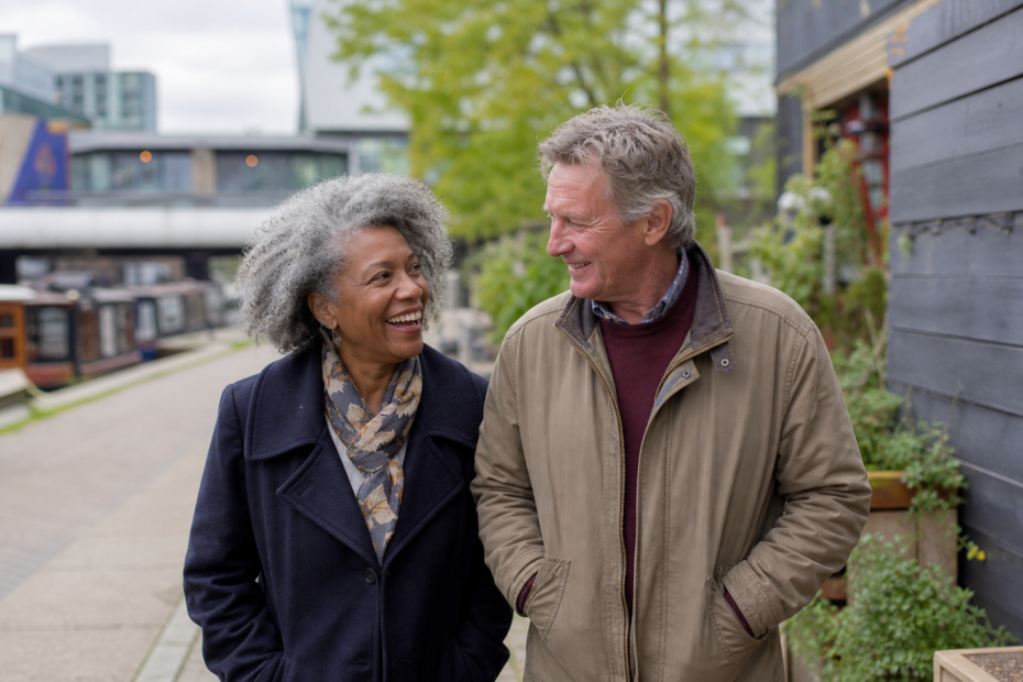 Mature couple over 60 enjoying a daytime walk beside Regents Canal in Camden